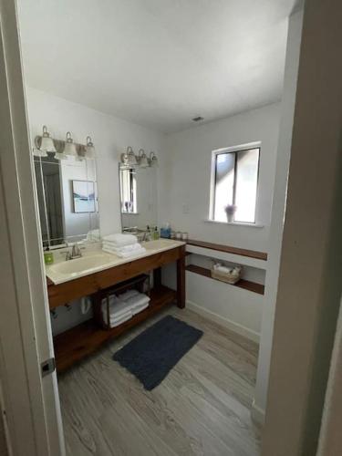 a bathroom with a sink and a mirror at 120 Creel Home away from Home for 22 at the Lake in Linn Creek