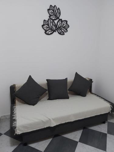 a couch in a room with a butterfly on the wall at Brignole B in Genoa
