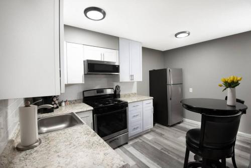 a kitchen with a sink and a stove and refrigerator at 604 1 Two Bedroom One Bath with King near Main Street in St. Charles