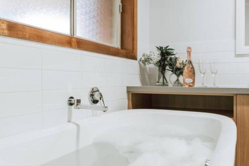 a white bath tub in a bathroom with a sink at Olinda Nature Retreat 4 Bed 3Bth House Fire, Bath in Olinda