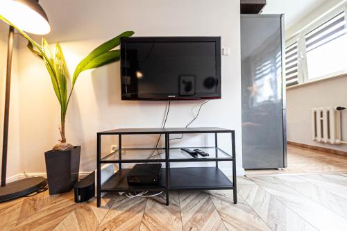 a living room with a tv on a wall at Garone in Gdańsk