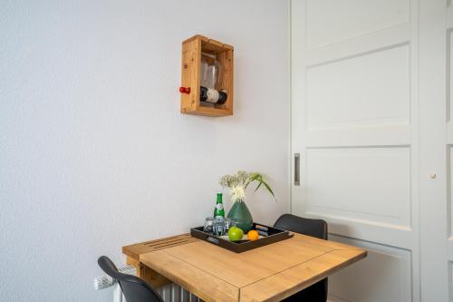 a dining room table with a tray of fruit on it at Nieuw Leven Texel in Den Burg