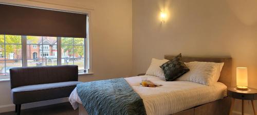 a bedroom with a bed with a stuffed animal on it at 1st Floor Flat Bennetthorpe Overlooking Doncaster Racecourse Free Parking in Doncaster