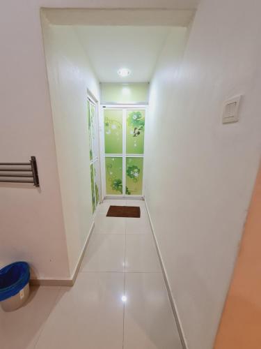a hallway with white walls and a window at Air-home No135 Kampung Boyan, 3BR, 6pax Netflix in Taiping