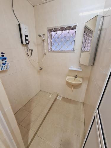 a bathroom with a shower and a sink at Air-home No135 Kampung Boyan, 3BR, 6pax Netflix in Taiping