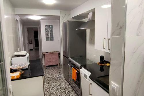 a kitchen with a refrigerator and a stove top oven at RELAX in Bellreguart