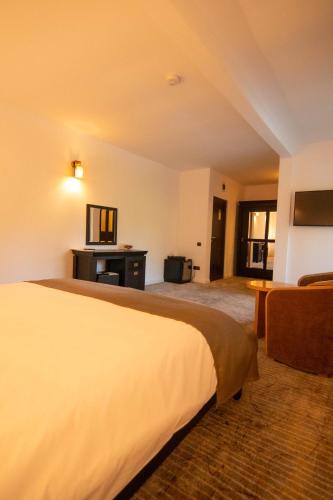 a hotel room with a bed and a couch at Hunter Vip in Reghin