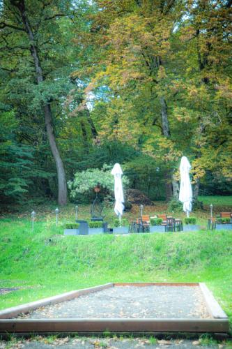 a park with two white statues in the grass at Hunter Vip in Reghin