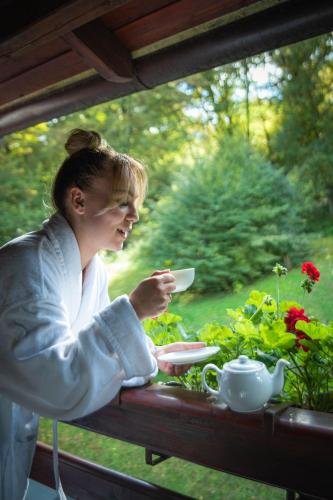 a woman sitting at a table with a plate of food at Hunter Vip in Reghin
