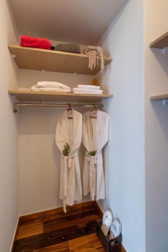 a room with white towels hanging on shelves at Villa Salty in Azolimnos Syros