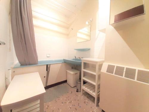 een kleine badkamer met een wastafel en een bureau bij Appartement Saint-Lary-Soulan, 3 pièces, 6 personnes - FR-1-457-309 in Saint-Lary-Soulan