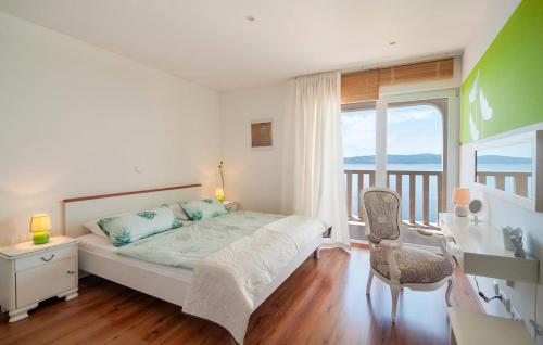 a bedroom with a bed and a desk and a window at Villa Anči in Pisak