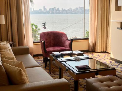 a living room with a view of the water at Hotel Marine Plaza in Mumbai