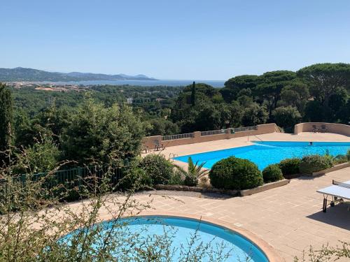 uma vista para uma piscina a partir de uma casa em Le 53 Bellevue em Cogolin