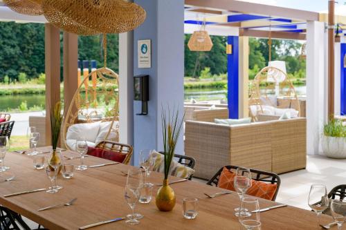 a dining room with a table with wine glasses at Ibis Styles Regensburg in Regensburg