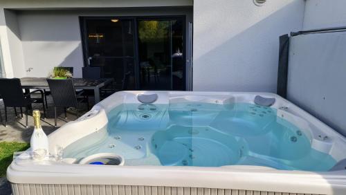 a jacuzzi tub in the backyard of a house at Luxusferienhaus Seevilla Monaco am Fleesensee in Göhren-Lebbin
