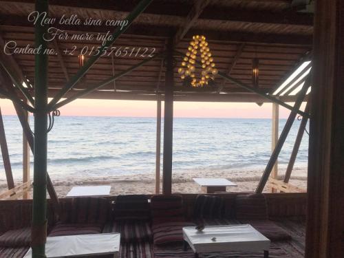 a view of the ocean from a beach restaurant at New Bella Sina Camp in Nuweiba