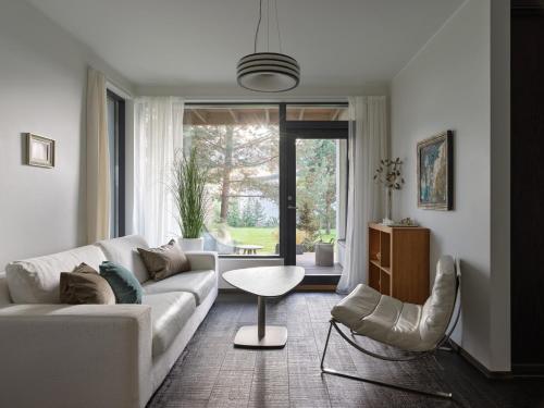 a living room with a white couch and a table at Sun Villa in Imatra