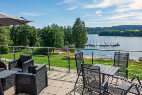 a patio with a view of the water and boats at Rezidence Sunny Hill in Frymburk