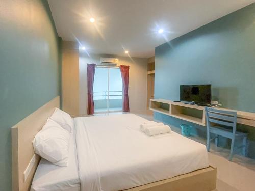 a small bedroom with a bed and a window at Hop On Phuket in Ban Bo Han