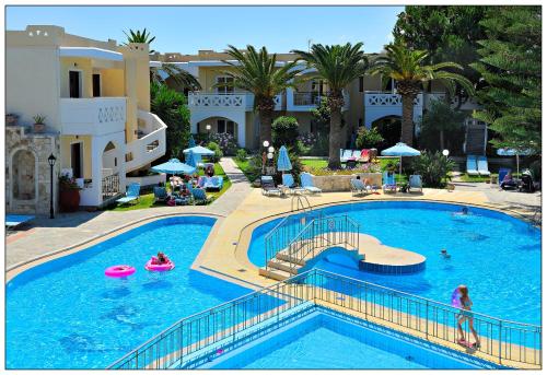 a large swimming pool with people in a resort at Kastalia Village ,Saint Nikolas resort in Kolymvari