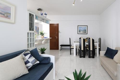 a living room with a couch and a table at Seaside Penthouse in Kalamata in Kalamata
