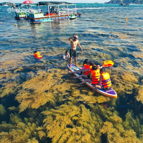 a group of people on a raft in the water at Xavia Hotel Quy Nhơn in Quy Nhon