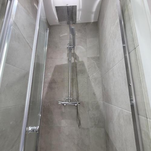 a shower with a glass door in a bathroom at Argyle Square Hotel in London