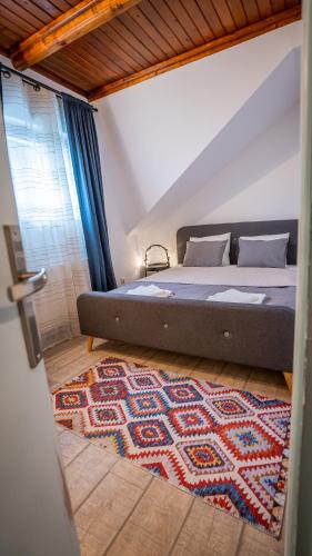 a bedroom with a bed and a rug on the floor at Family TreeZ Premium Apartments in Poiana Brasov