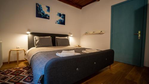 a bedroom with a bed and a blue door at Family TreeZ Premium Apartments in Poiana Brasov