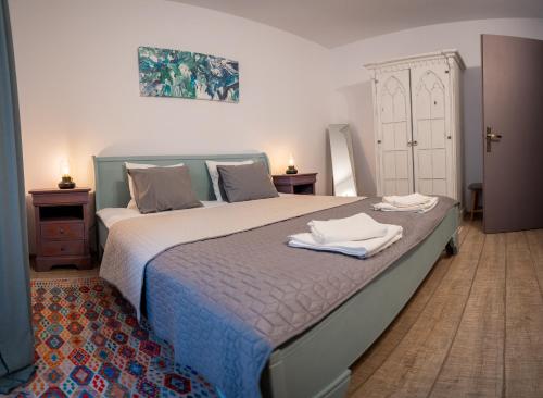 a bedroom with a bed with two towels on it at Family TreeZ Premium Apartments in Poiana Brasov