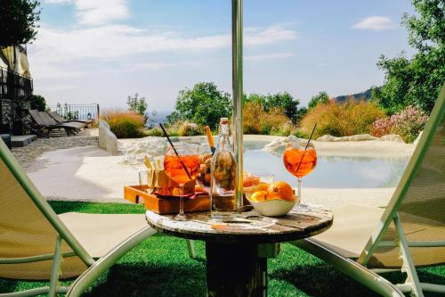 a table with drinks and a bowl of fruit on it at AGRITURISMO CA' FENILE in Alzano Lombardo