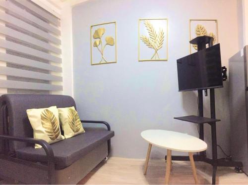 a living room with a chair and a tv at Cabuhat Duco Lodge 2 in Naic