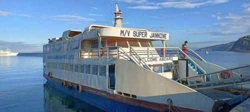 a cruise ship is docked in the water at Manzil Anilao B&B in Mabini