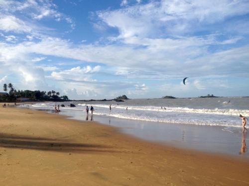 a group of people on a beach with a kite at Le 5 Nord in Cayenne