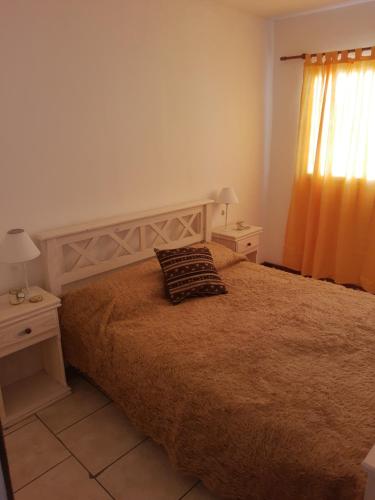 a bedroom with a bed with a pillow on it at Umi del sur in Mar del Plata