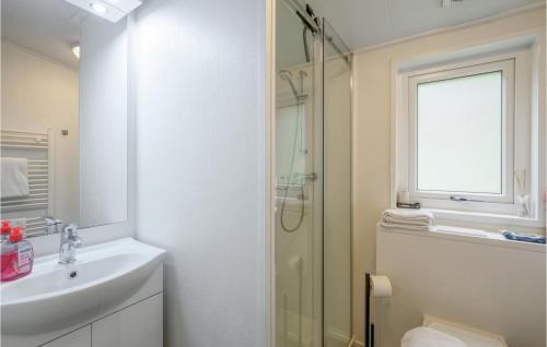 a white bathroom with a shower and a sink at 2 Bedroom Amazing Home In Ssel in Süsel
