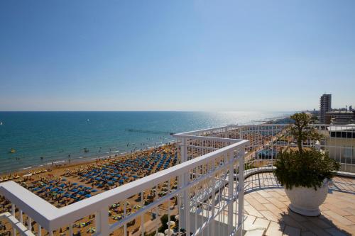 a view of the beach from the balcony of a resort at Termini Beach Hotel & Suites in Lido di Jesolo