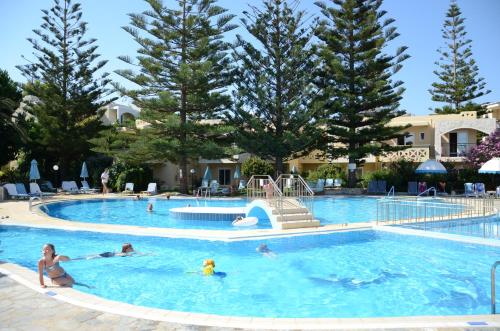 a group of people in the swimming pool at a resort at Kastalia Village ,Saint Nikolas resort in Kolymvari