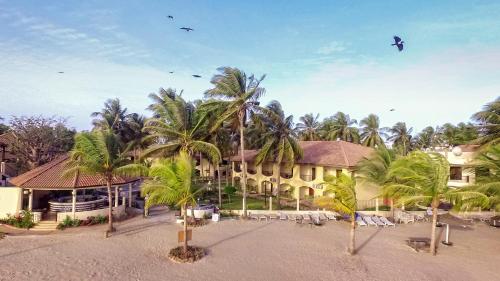 a resort with palm trees in front of a building at Ocean Bay Hotel & Resort in Bathurst