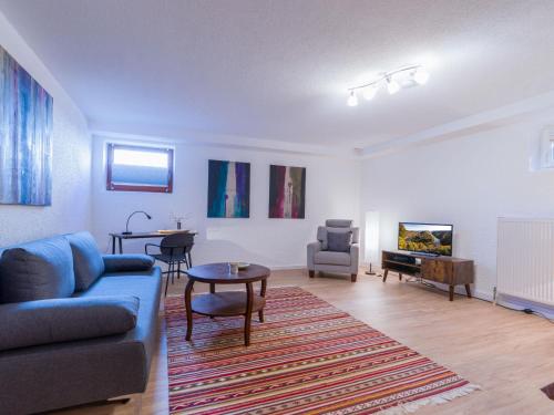 a living room with a couch and a table at Ferienwohnung Auszeit in Losheim