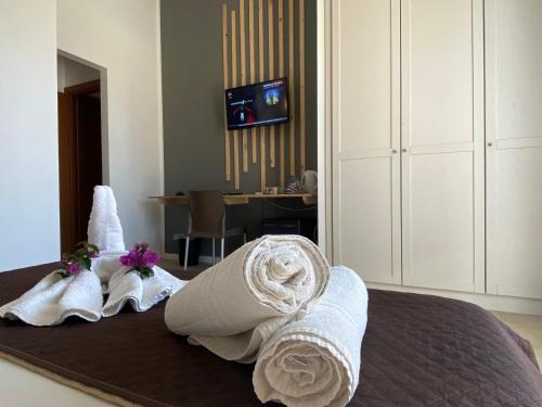 a hotel room with towels on a bed at ProKite Alby Rondina - RESORT - in Birgi Vecchi