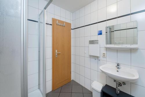 a bathroom with a sink and a mirror and a shower at Hotel Bamberger Hof, garni in Eisenach