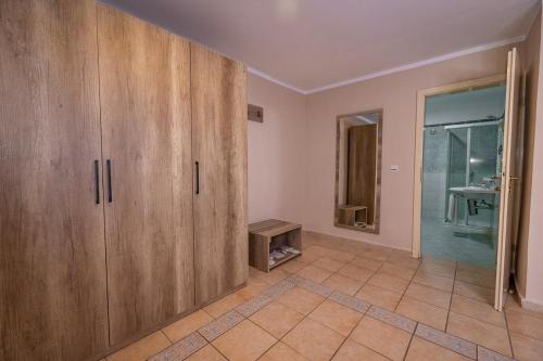 a room with wooden cabinets and a bathroom at Ocean Bay Hotel & Resort in Bathurst