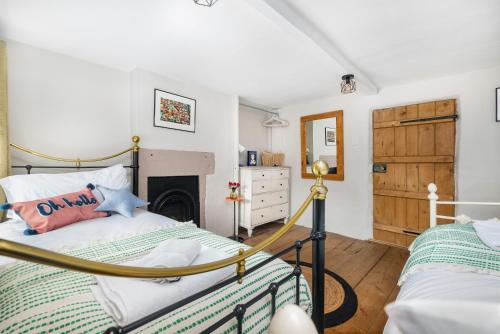 a bedroom with a bed and a fireplace at No 9 The Hill Cromford Nr Matlock Bath in Cromford