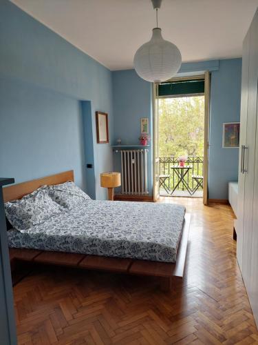 a bedroom with a bed with a blue wall at Casa Turati in Turin