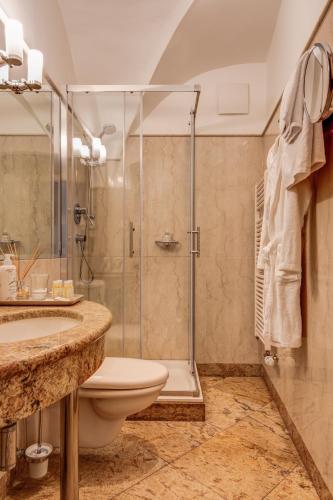 a bathroom with a shower and a toilet and a sink at Hotel Nerudova 211 in Prague