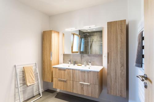 a bathroom with a sink and a mirror at La Grande Croix Bienvenue in Saint-Cast-le-Guildo