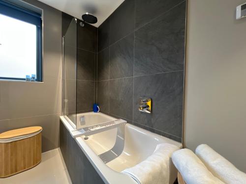 a bathroom with a bath tub and a toilet at River Vista Retreat - Luxury duplex Apt - Views - Parking - Cycle storage - Spa access option in Backbarrow