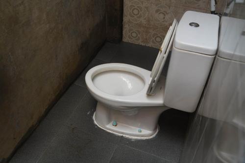 a bathroom with a toilet in a stall at Happy House BnB Bromo backpacker in Probolinggo